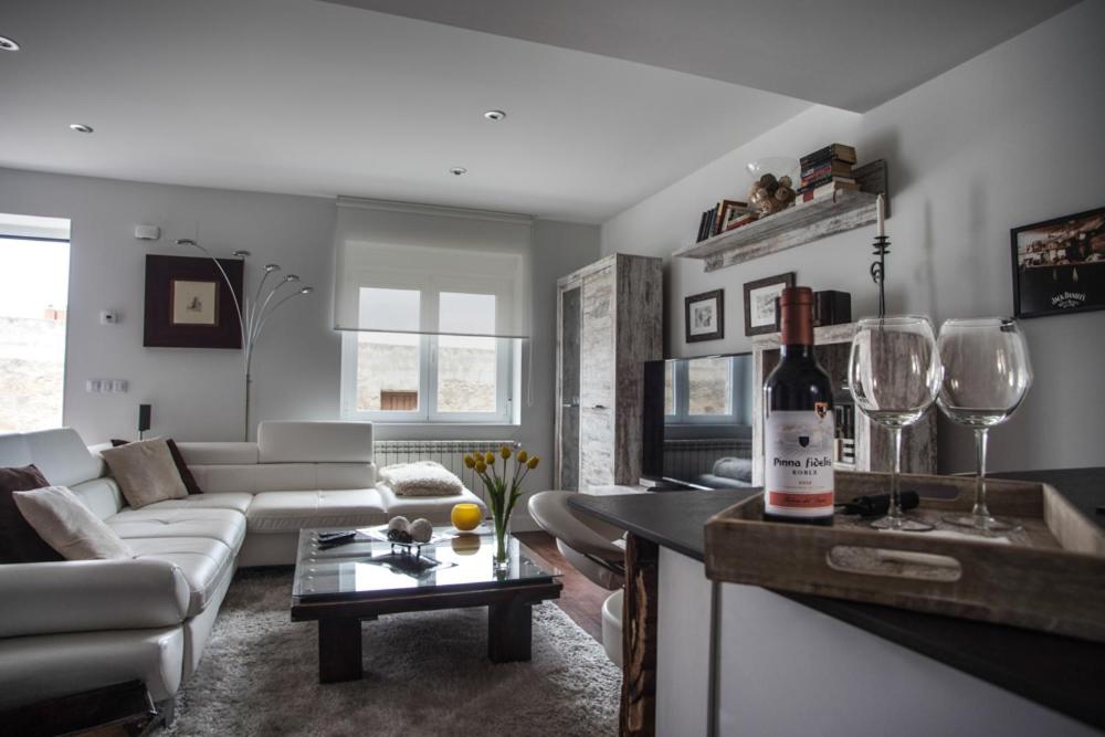 a living room with a bottle of wine on a counter at EL PATIO DE MI CASA in Avila