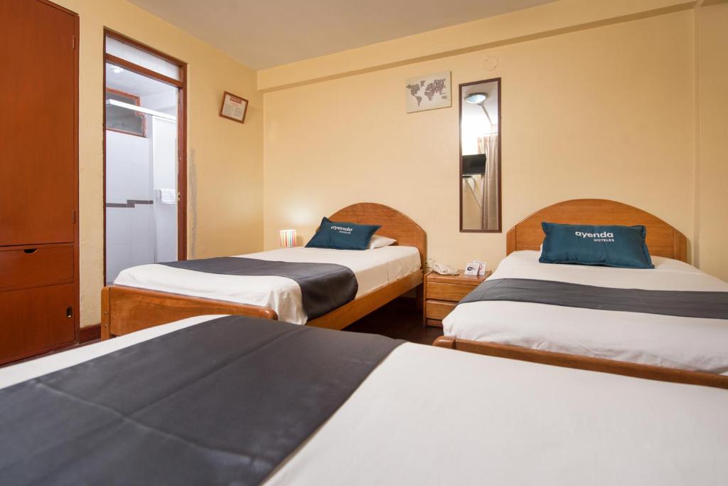 Uma cama ou camas num quarto em Ayenda Posada Inn