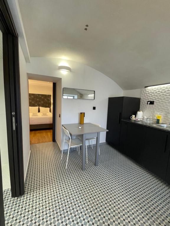 a kitchen with a table in the middle of a room at Fisherman's Albufeira Cosy Studio in Albufeira
