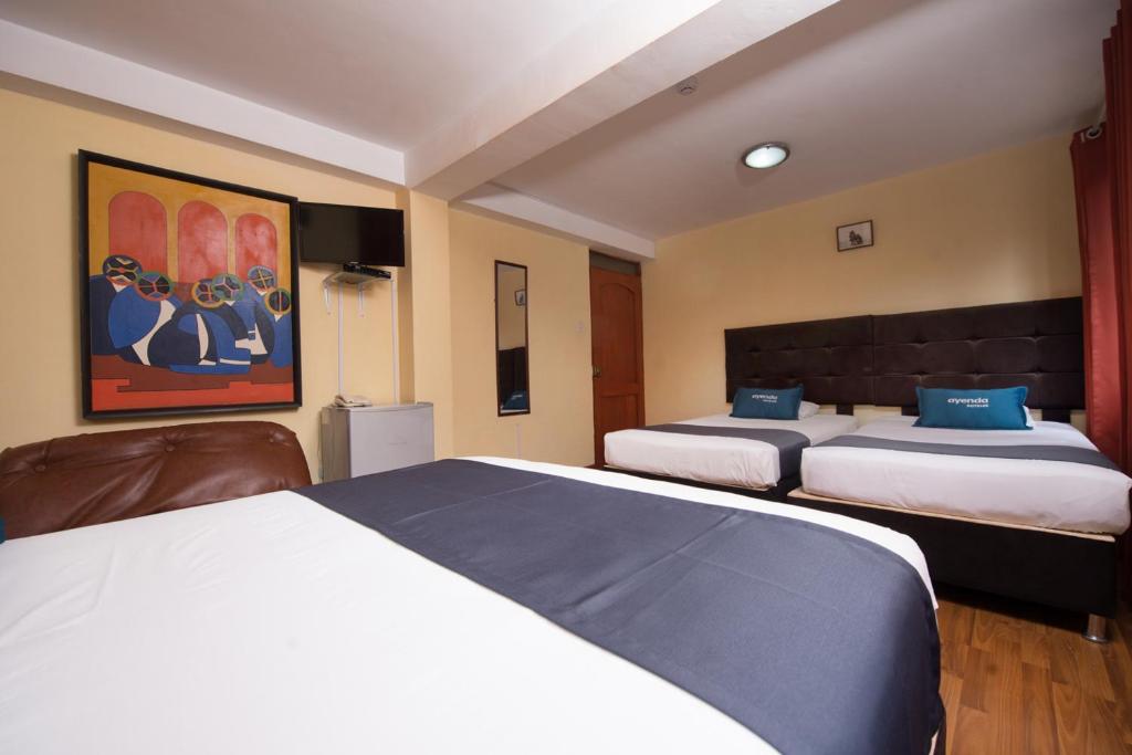 Uma cama ou camas num quarto em Ayenda Posada Inn