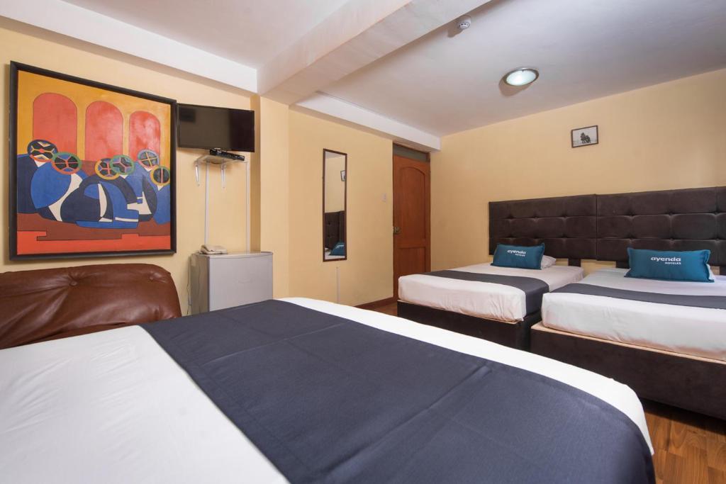 Uma cama ou camas num quarto em Ayenda Posada Inn