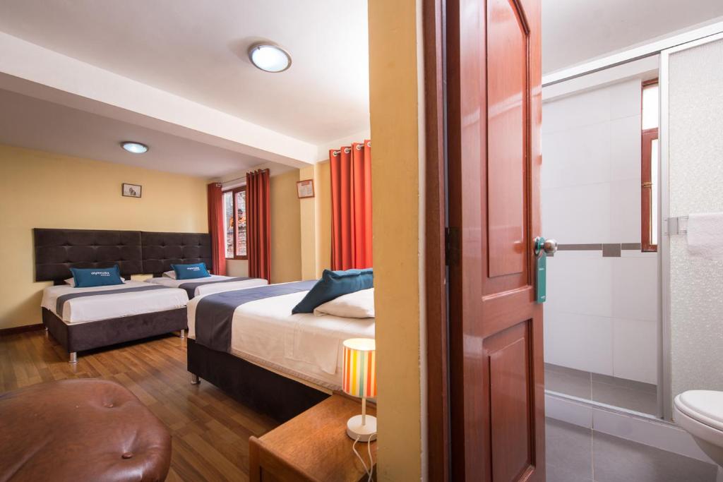 Uma cama ou camas num quarto em Ayenda Posada Inn