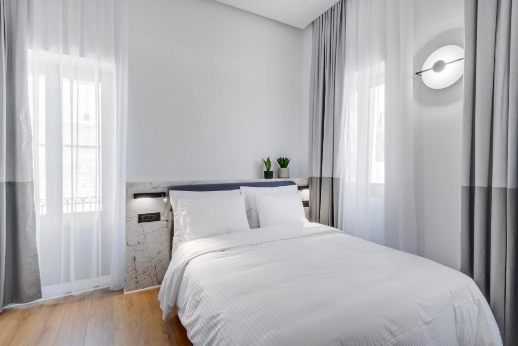 Posteľ alebo postele v izbe v ubytovaní Times Elegant Rooms