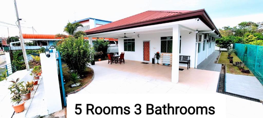 a white house with rooms bathrooms at Kota Kinabalu Sabah City Homestay in Kota Kinabalu