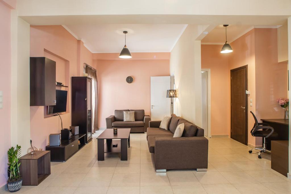 a living room with two couches and a tv at Agios Pavlos Corner Vacation House Zakinthos in Zakynthos Town