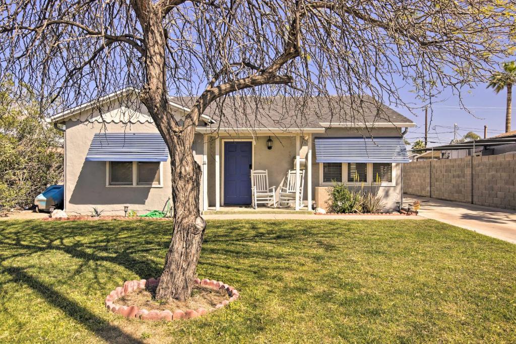 a small house with a tree in the yard at 2 Mi to Dtwn Phoenix Cottage with Private Yard! in Phoenix
