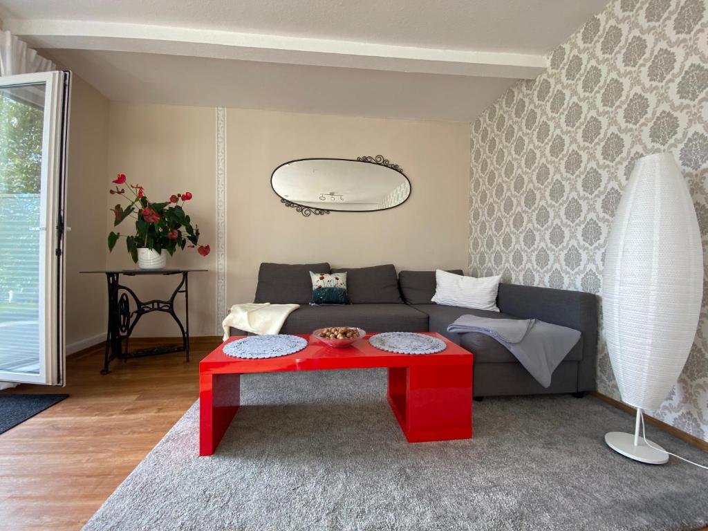 a living room with a couch and a red table at Ferienwohnung Traumreich in Bad Harzburg