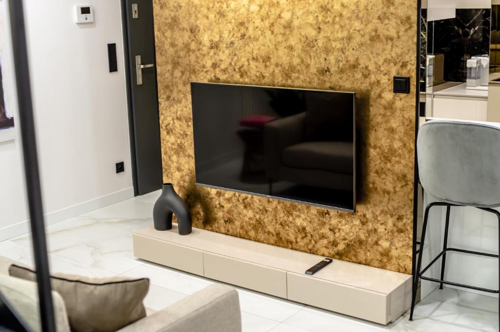 Televízia a/alebo spoločenská miestnosť v ubytovaní Super-Apartamenty VIP Jacuzzi II