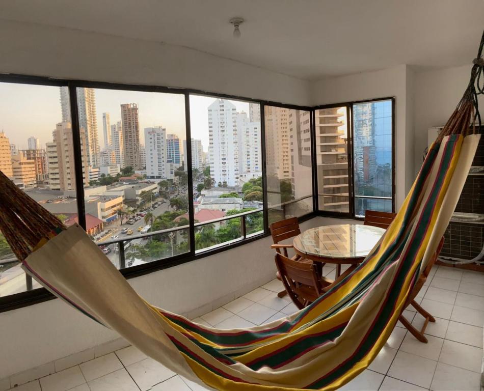 a room with a hammock and a table with a view at Bocagrande Escape 1002AT Cartagena in Cartagena de Indias