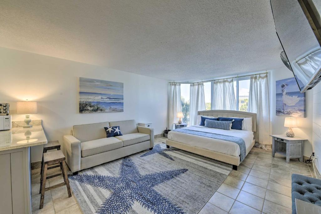 a bedroom with a bed and a couch at Sandpiper Studio with Resort Pool and Beach Access! in Panama City Beach