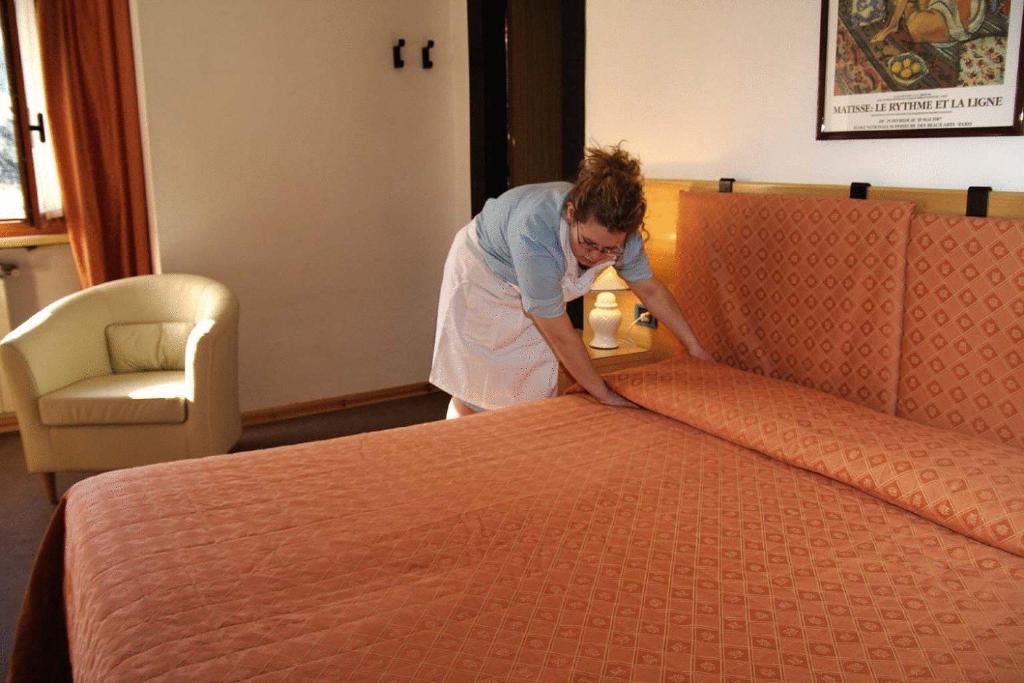 Postel nebo postele na pokoji v ubytování Hotel Des Geneys