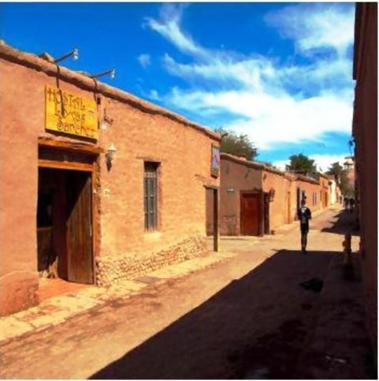 a person walking down a street next to a building at Loma Sanchez in San Pedro de Atacama