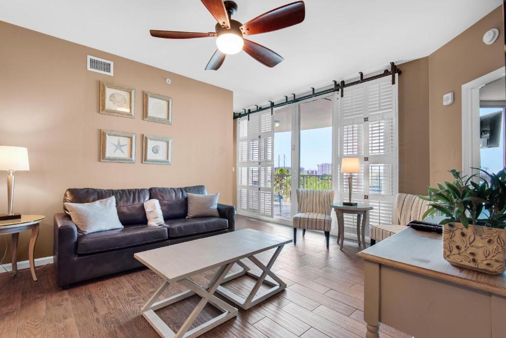 a living room with a couch and a ceiling fan at Palms Resort #2416 Full 2 Bedroom in Destin