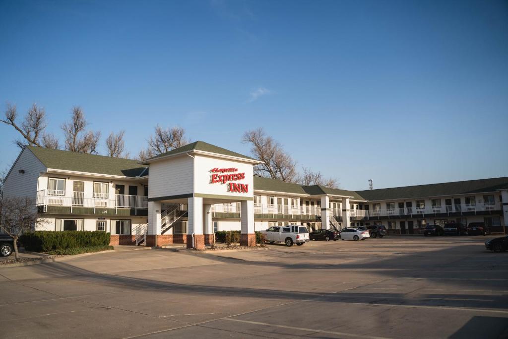 a hotel with a fast food sign in a parking lot at Haysville Express Inn in Haysville