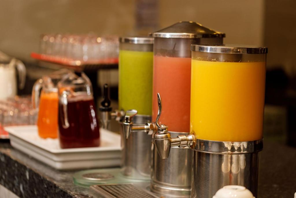 three glasses of juice sitting on a counter at Camino Real Aeropuerto in Mexico City