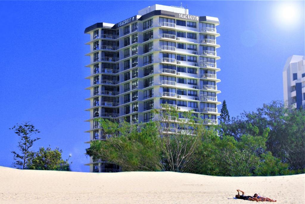 a building sitting on top of a sandy beach at Seacrest Beachfront Apartments Surfers Paradise in Gold Coast