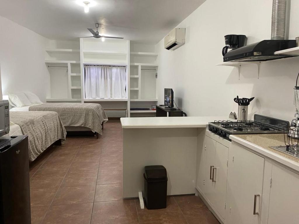 a room with a kitchen and a room with two beds at CASA ROMEL in Ciudad Valles