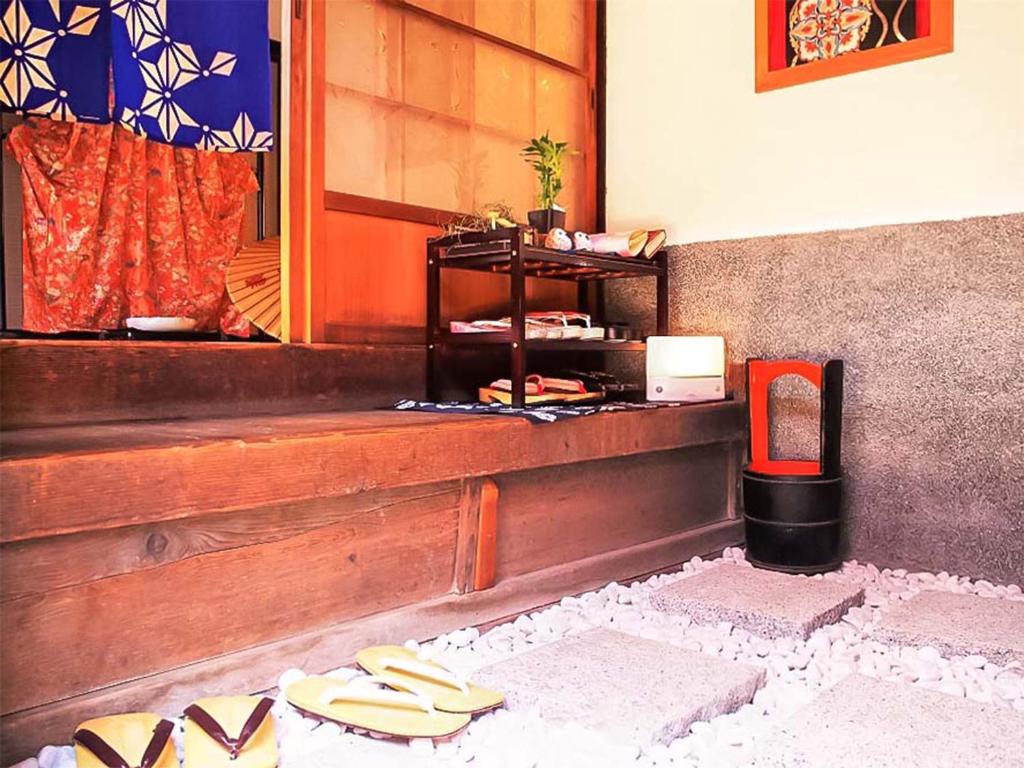 Postel nebo postele na pokoji v ubytování Guest House Kominka Nagomi