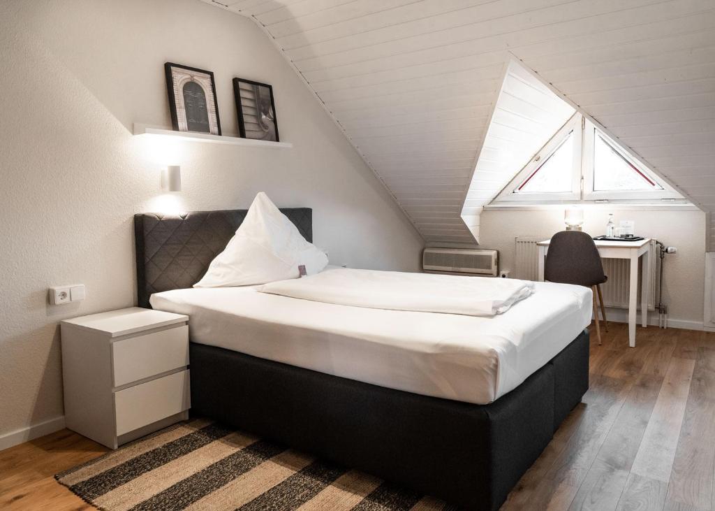 a bedroom with a large bed in a attic at Hotel Beim Schupi Karlsruhe in Karlsruhe