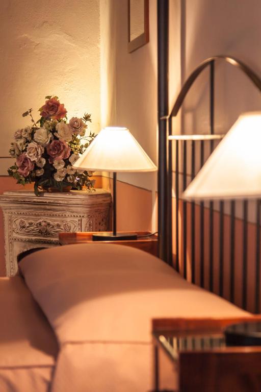 Postel nebo postele na pokoji v ubytování Hotel L'Antico Pozzo