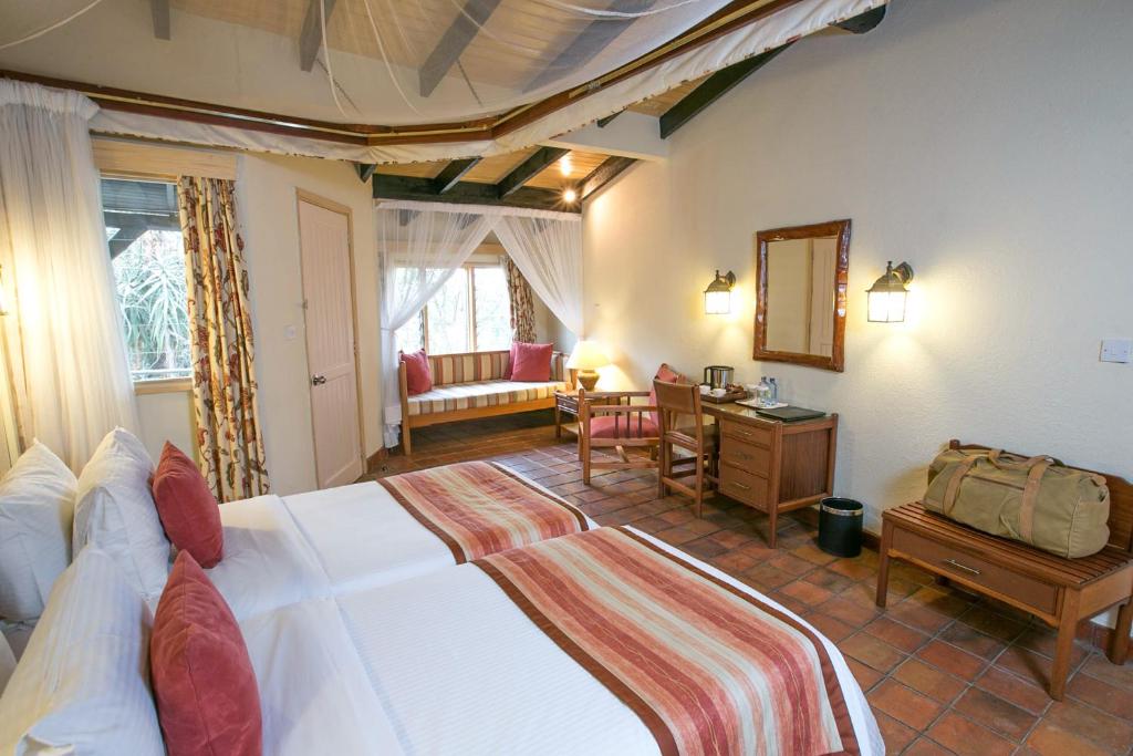 Postel nebo postele na pokoji v ubytování Sarova Lion Hill Game Lodge