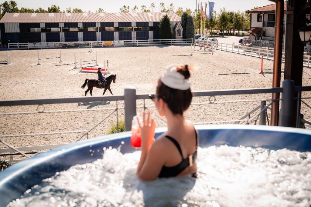 a woman in a hot tub with a horse at Boutique Complex Trakiets in Duvanlii