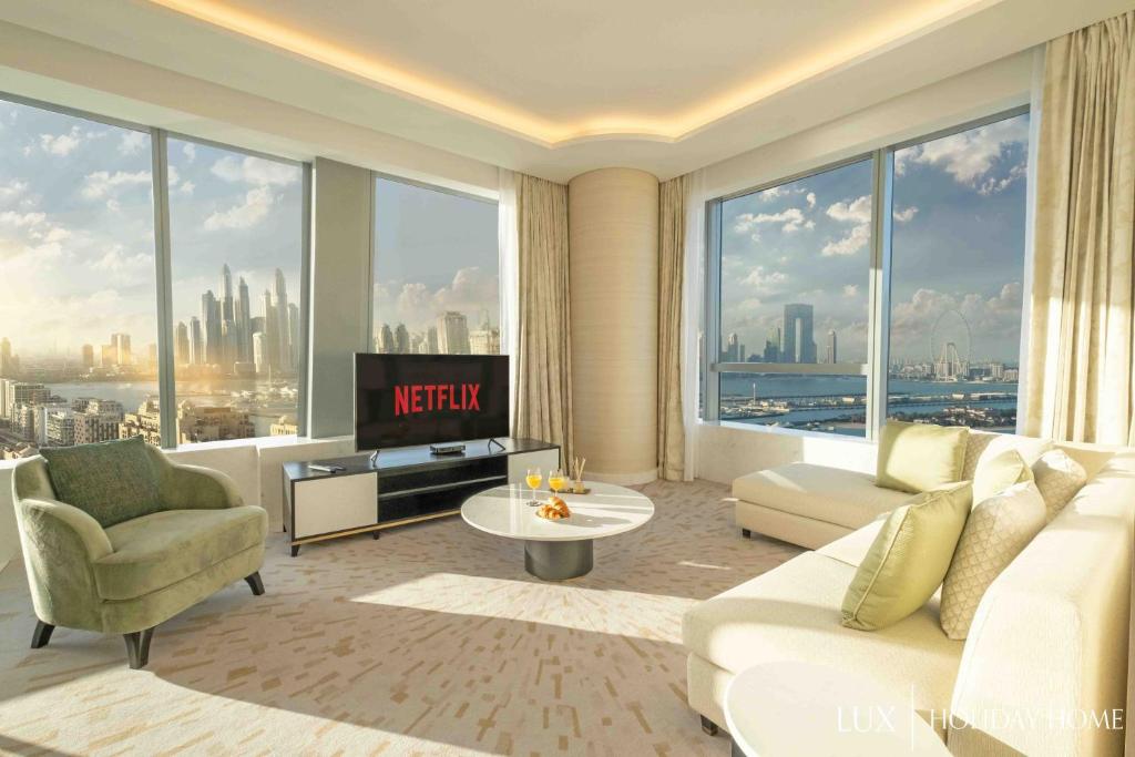 a living room with a view of a city at LUX Iconic Views at The Palm Tower Suite 2 in Dubai