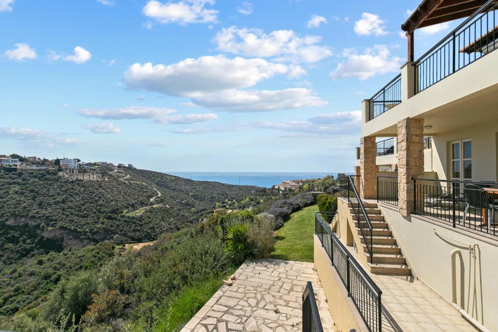 a house with a view of the ocean at 2 bedroom Apartment Avdimou with stunning sea views, Aphrodite Hills Resort in Kouklia