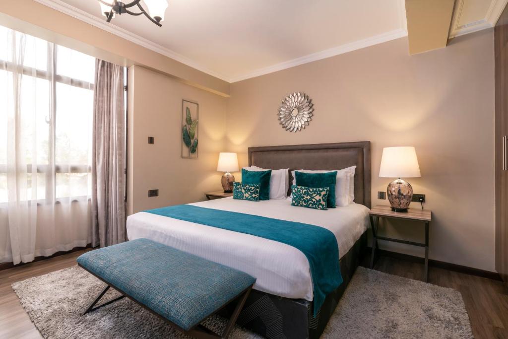 Een bed of bedden in een kamer bij Fair Acres Boutique Hotel Karen