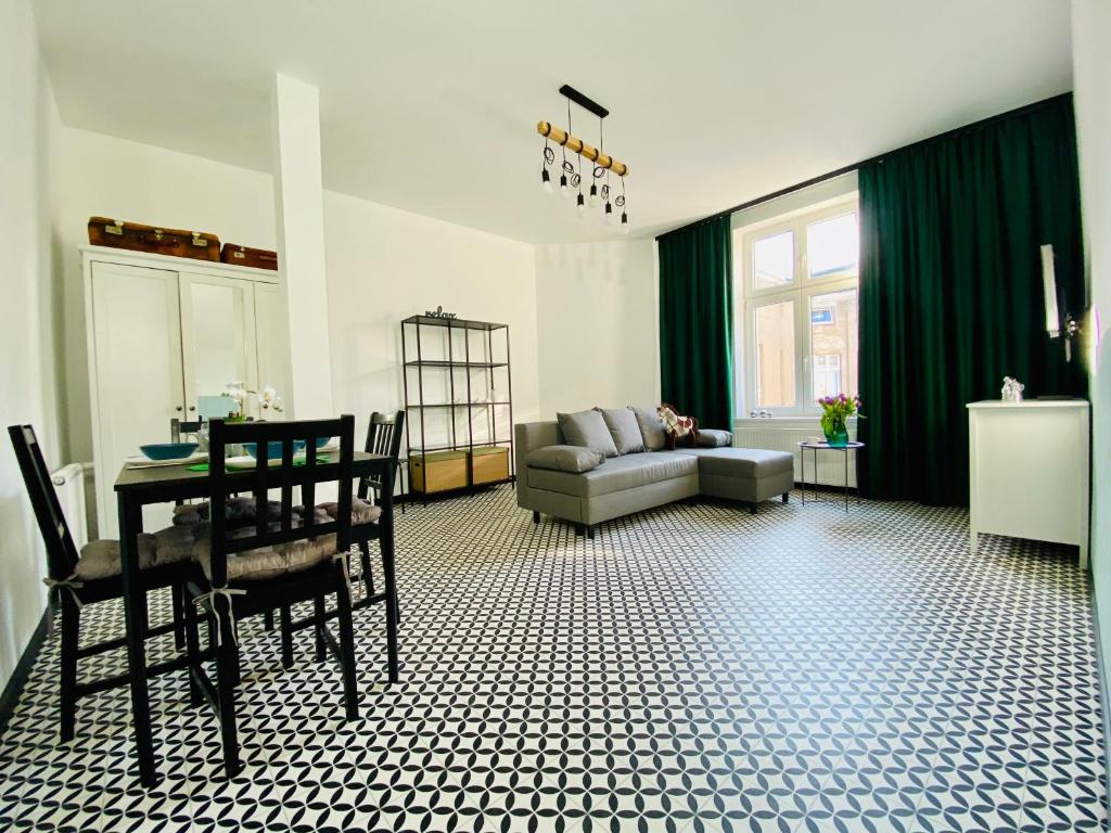 a living room with a couch and a table at Angel Apartment Taczaka in Poznań