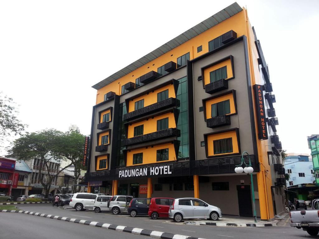 a building with cars parked in front of it at Padungan Hotel in Kuching