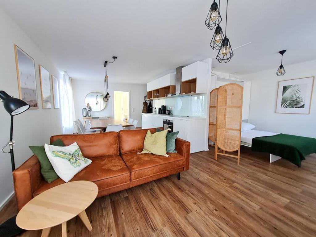 a living room with a couch and a kitchen at Ferienwohnung Maja-Katharina in Bad Saarow