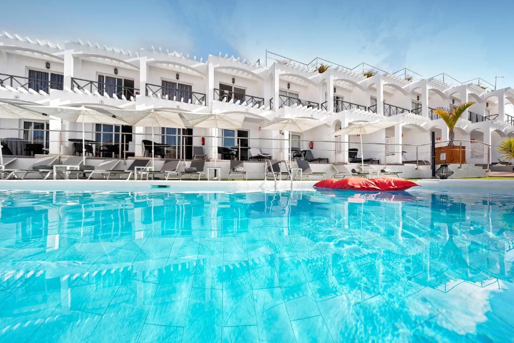 a hotel room with a pool and a swimming pool at Vista Bonita - Gay and Lesbian Only Resort in Maspalomas