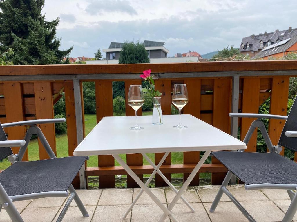 a white table with two glasses of wine on a deck at Lovely Central Located- Train, Restaurants & Spa in Kassel