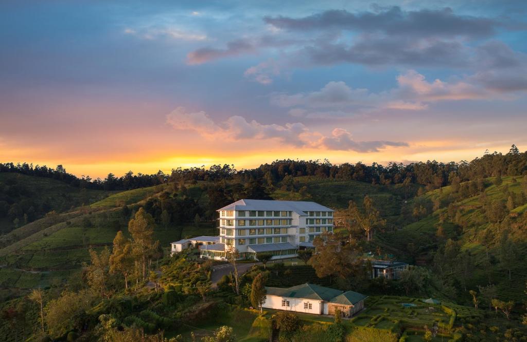 an aerial view of a building in the middle of a hill at Heritance Tea Factory in Nuwara Eliya
