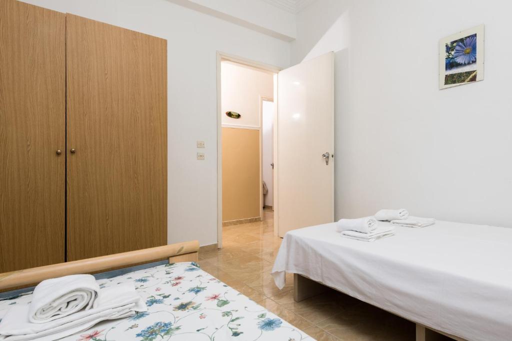 Łóżko lub łóżka w pokoju w obiekcie Aigli House
