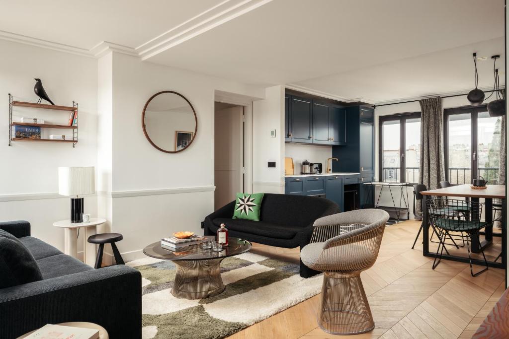 a living room with a couch and a table at My Maison In Paris Invalides in Paris