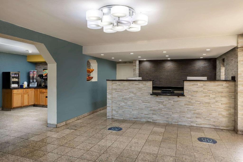 a lobby with a reception desk in a hospital at Days Inn by Wyndham Raleigh Midtown in Raleigh