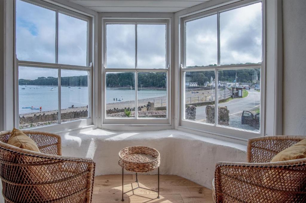 a room with large windows with a view of the ocean at Brook Cottage Green - 2 Bedroom Cottage - Dale in Dale