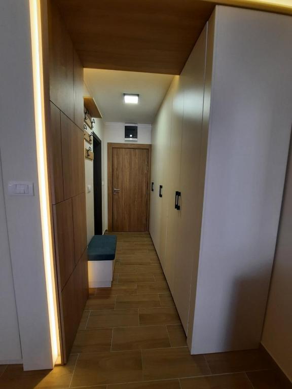 a hallway leading to a door in a room at Apartman Radmila in Kopaonik
