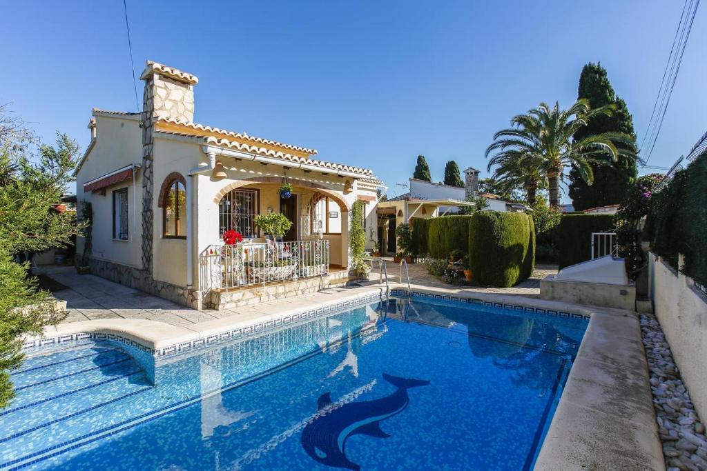 a house with a swimming pool in front of a house at 003 Villa Muñeca - Deniasol in Denia