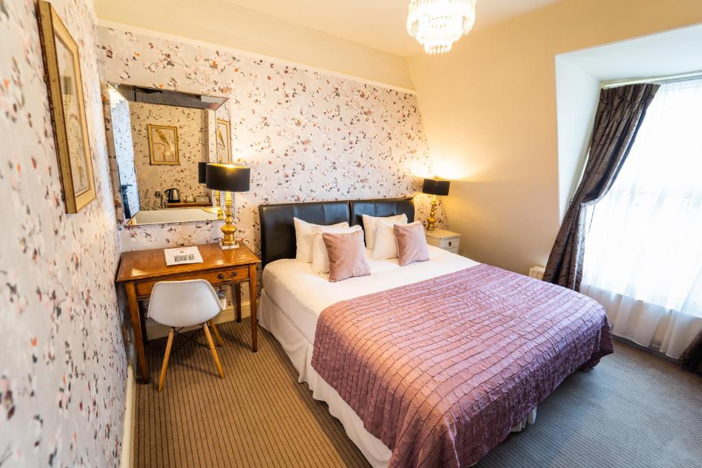 a bedroom with a large bed and a large mirror at Brooks Guesthouse in Bath