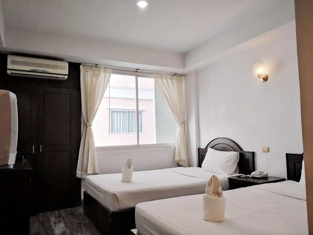 Postel nebo postele na pokoji v ubytování Sun Moon Hotel