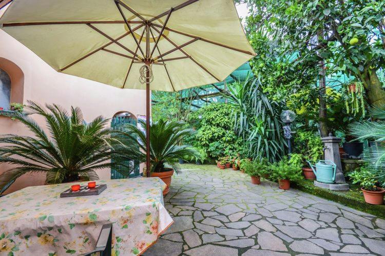 patio ze stołem i parasolem w obiekcie Apartment Sorrento 2 w Sorrento