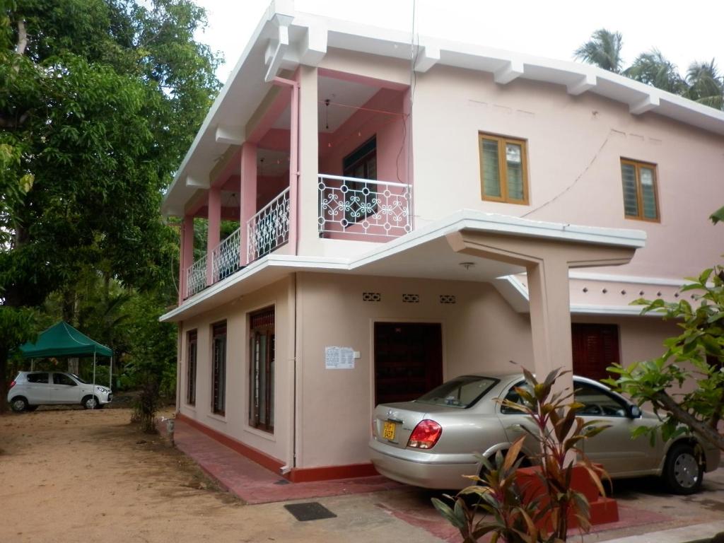 a house with a car parked in front of it at Luxman Guest House in Polonnaruwa