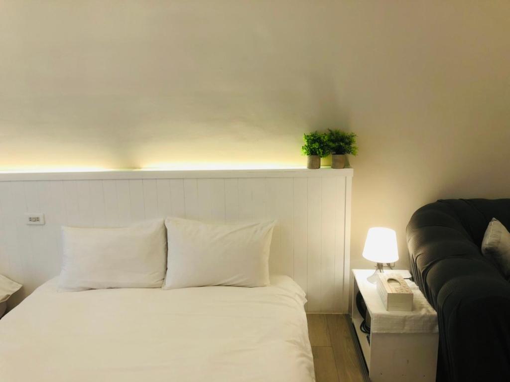 Postel nebo postele na pokoji v ubytování 海沐輕旅 Sea Mu Kenting
