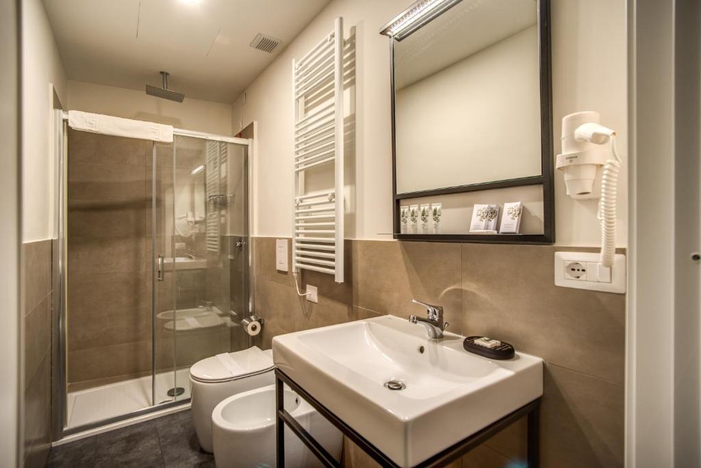 a bathroom with a sink and a shower and a toilet at Capranica Private Suites in Rome