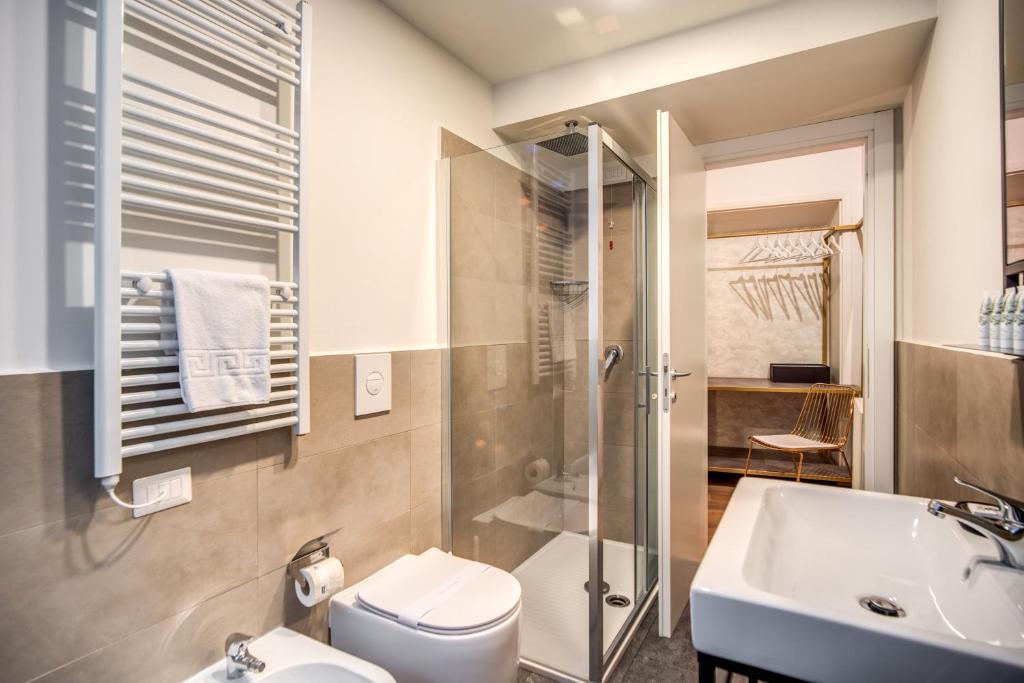 a bathroom with a sink and a toilet and a shower at Capranica Private Suites in Rome