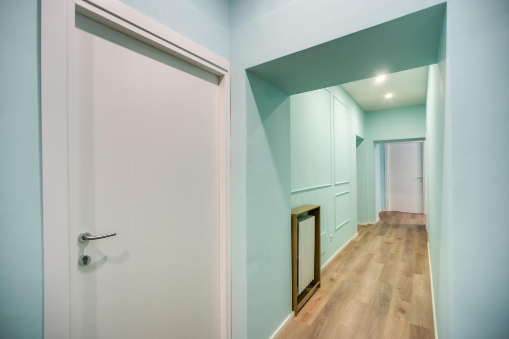 a hallway with a door and a fireplace at Capranica Private Suites in Rome