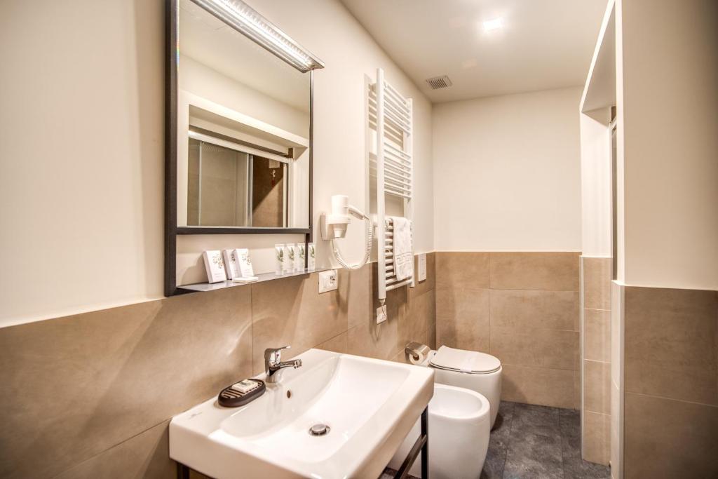 a bathroom with a sink and a toilet at Capranica Private Suites in Rome